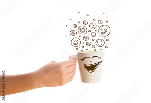 Photo: Coffee-cup with brown hand drawn happy smiley faces Coffee-cup with brown hand drawn happy smiley faces