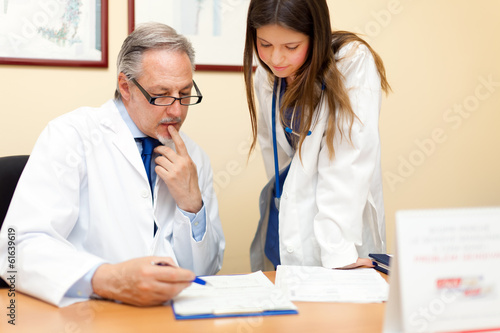Photo: Portrait of a doctor and his assistant in his studio Portrait of a doctor and his assistant in his studio