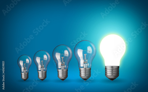 Photo: Row of light bulbs.Idea concept on blue background. Row of light bulbs.Idea concept on blue background.