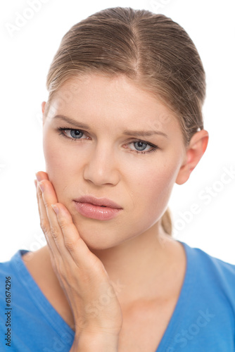 Photo: Dental care. Young woman suffering from toothache, isolated Dental care. Young woman suffering from toothache, isolated