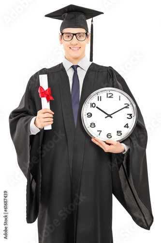 Photo: Male graduate student holding a diploma and big wall clock Male graduate student holding a diploma and big wall clock