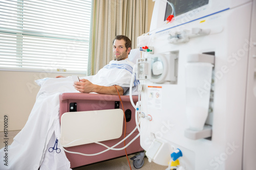 Photo: Patient Holding Cellphone During Renal Dialysis Treatment Patient Holding Cellphone During Renal Dialysis Treatment