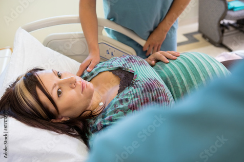 Photo: Pregnant Woman Looking At Nurse While Colleague Consoling Her Pregnant Woman Looking At Nurse While Colleague Consoling Her