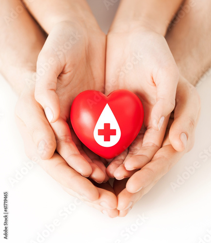 Photo: hands holding red heart with donor sign hands holding red heart with donor sign