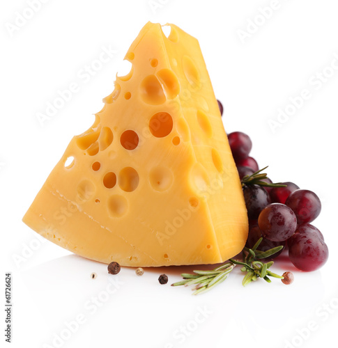 Photo: Piece of cheese with grape and rosemary, isolated on white Piece of cheese with grape and rosemary, isolated on white