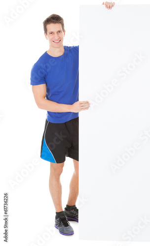Photo: Young Man Holding Placard Young Man Holding Placard