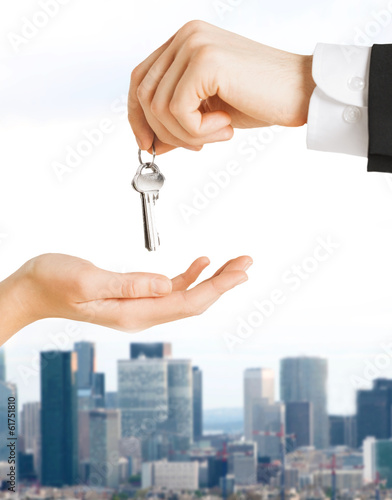 Photo: close up of man and woman with house keys close up of man and woman with house keys
