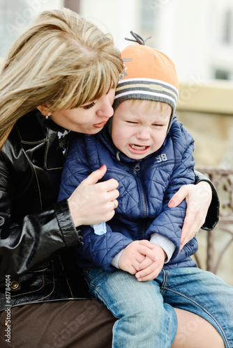 Photo: mother calming son mother calming son