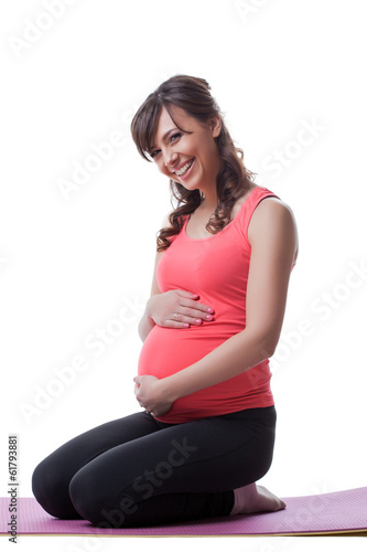 Photo: Image of happy pregnant woman posing during yoga Image of happy pregnant woman posing during yoga