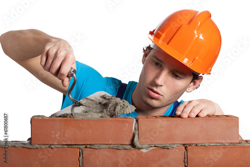 Photo: Concentrated bricklayer putting Concentrated bricklayer putting