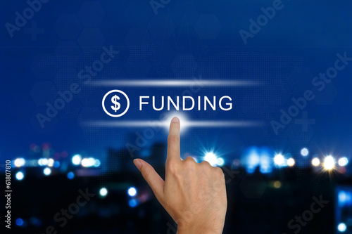 Photo: hand pushing funding button on touch screen hand pushing funding button on touch screen