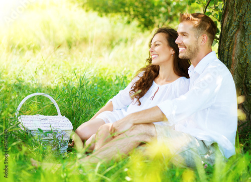 Photo: Beautiful Young Couple Having Picnic in Countryside Beautiful Young Couple Having Picnic in Countryside