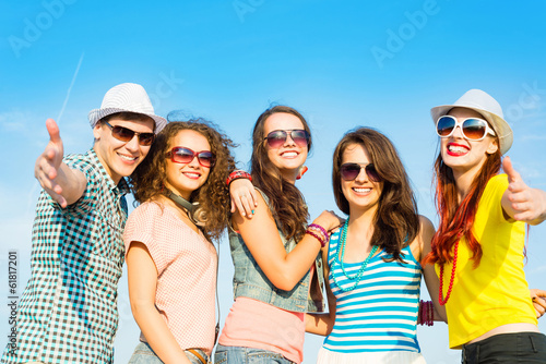 Photo: group of young people wearing sunglasses and hat group of young people wearing sunglasses and hat