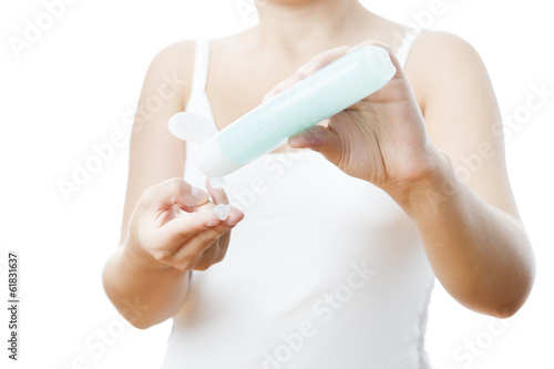 Photo: Bottle with cream in a female hand Bottle with cream in a female hand