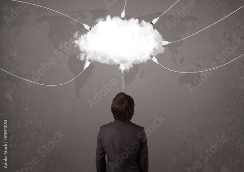 Photo: Young man looking at cloud transfer world service Young man looking at cloud transfer world service