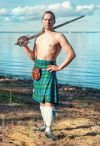 Photo: Scottish man with sword near the sea Scottish man with sword near the sea