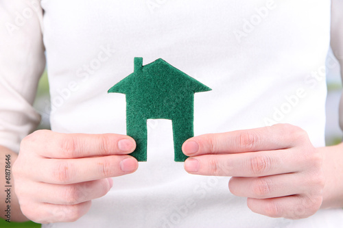 Photo: Little paper house in hand close-up Little paper house in hand close-up