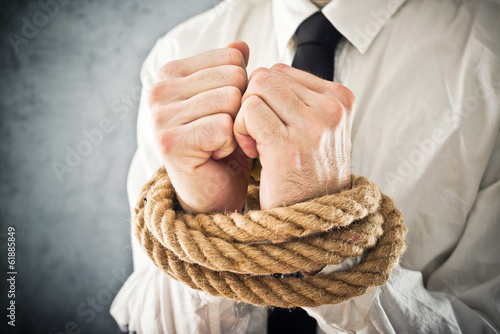 Photo: Businessman with hands tied in ropes Businessman with hands tied in ropes