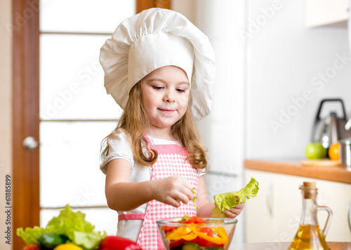 Photo: cute girl preparing healthy food vegetable salad cute girl preparing healthy food vegetable salad
