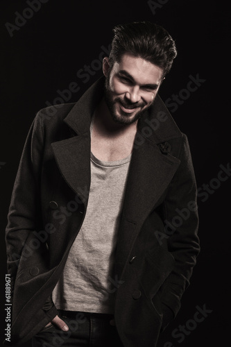 Photo: relaxed fashion man with beard smiling, hands in pockets relaxed fashion man with beard smiling, hands in pockets