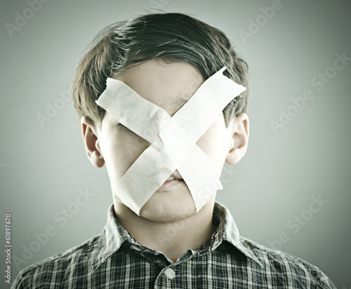 Photo: Portrait of kid with x shape on his face Portrait of kid with x shape on his face