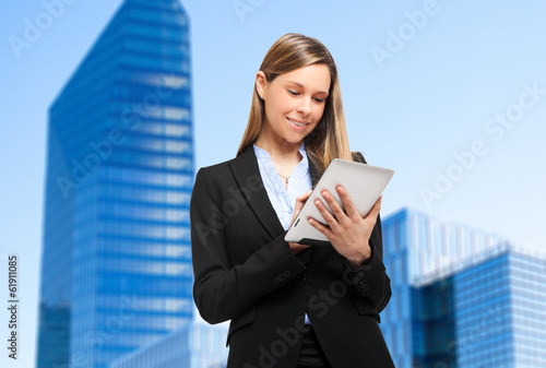 Photo: Smiling businesswoman using a tablet Smiling businesswoman using a tablet