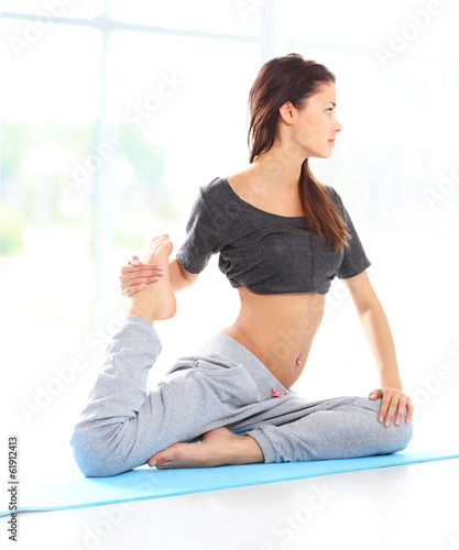 Photo: Fit young female training physically at the gym Fit young female training physically at the gym