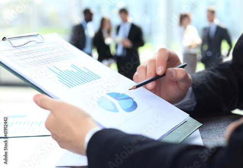 Photo: male hand pointing at business document during discussion male hand pointing at business document during discussion