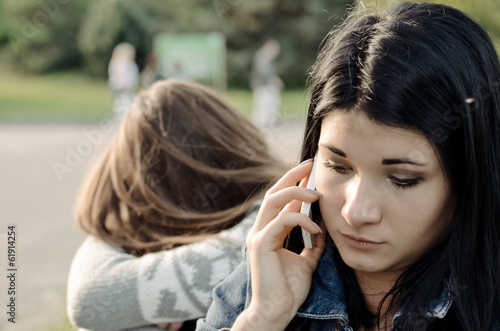 Photo: Beautiful young woman chatting on her mobile phone Beautiful young woman chatting on her mobile phone