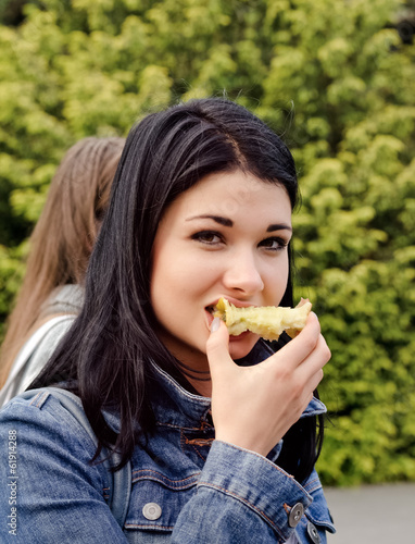 Photo: Young woman eating an apple Young woman eating an apple