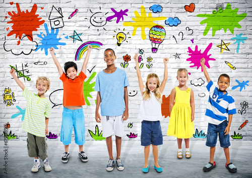 Photo: Group of Children Painting on the Brick Wall Group of Children Painting on the Brick Wall