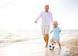 Father and Son Playing Ball on Beach Father and Son Playing Ball on Beach
