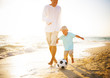 Father and Son Playing on the Beach Father and Son Playing on the Beach