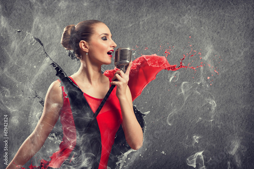 Photo: attractive female singer with microphone attractive female singer with microphone