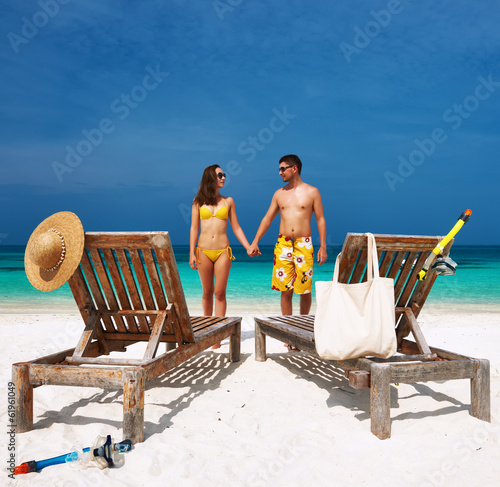 Photo: Couple in yellow on a beach at Maldives Couple in yellow on a beach at Maldives