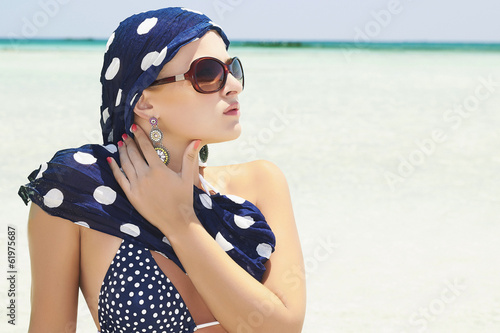 Photo: Beautiful Woman in Sunglasses on the Beach. Summer time Beautiful Woman in Sunglasses on the Beach. Summer time