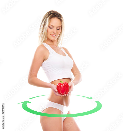 Photo: A young and sexy girl holding a red paprika on white A young and sexy girl holding a red paprika on white