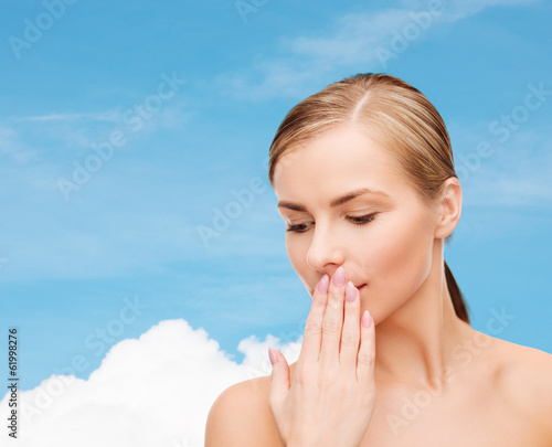 Photo: young woman doing hush gesrute young woman doing hush gesrute