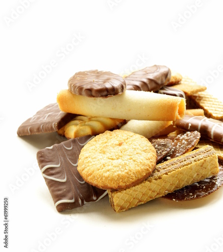 Photo: Assorted cookies with chocolate and nuts on white background Assorted cookies with chocolate and nuts on white background