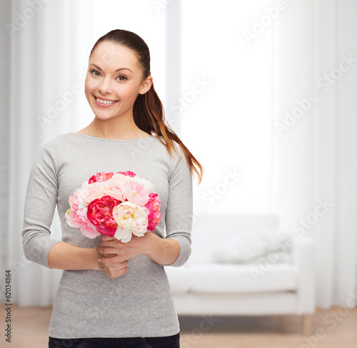 Photo: young woman with bouquet of flowers young woman with bouquet of flowers
