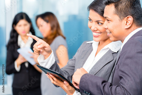 Photo: Asian Businesspeople having meeting in office Asian Businesspeople having meeting in office