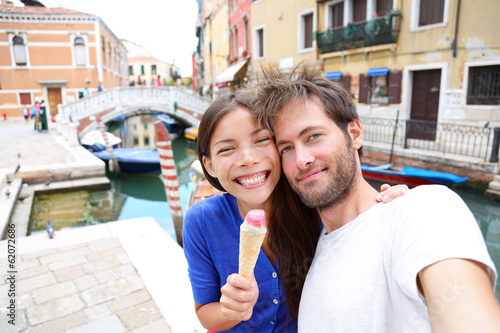 Photo: Couple in Venice, eating Ice cream taking selfie Couple in Venice, eating Ice cream taking selfie