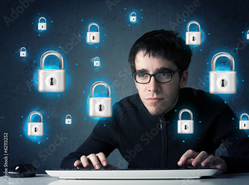 Photo: Young hacker with virtual lock symbols and icons Young hacker with virtual lock symbols and icons