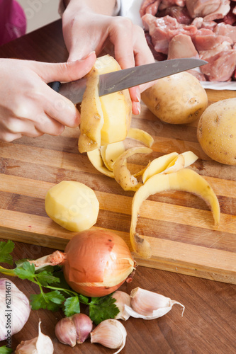 Photo: female hands cleaning potatoes female hands cleaning potatoes