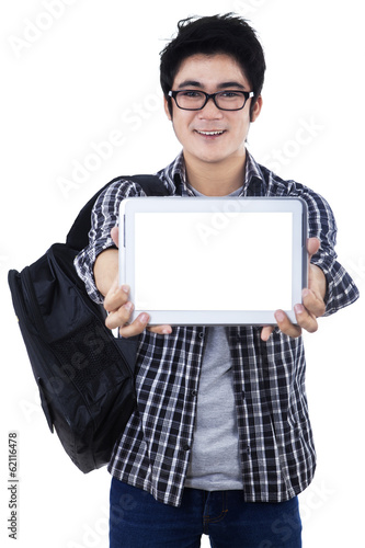Photo: Male student showing copyspace on digital tablet Male student showing copyspace on digital tablet