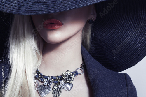 Photo: Beautiful Blond Woman in Black Hat.Spring.Accessories jewelry Beautiful Blond Woman in Black Hat.Spring.Accessories jewelry