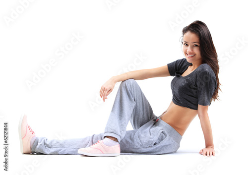 Photo: Beautiful young woman relaxing after doing exercise Beautiful young woman relaxing after doing exercise