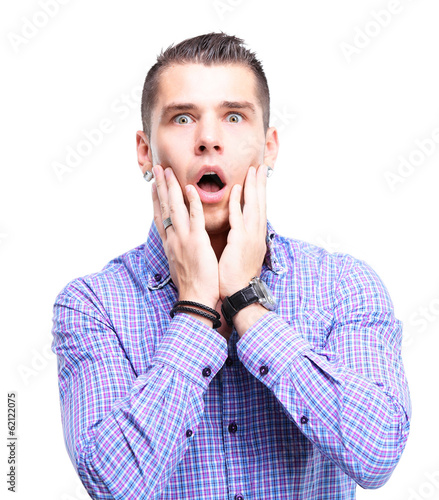 Photo: Portrait of young man with shocked facial expression Portrait of young man with shocked facial expression