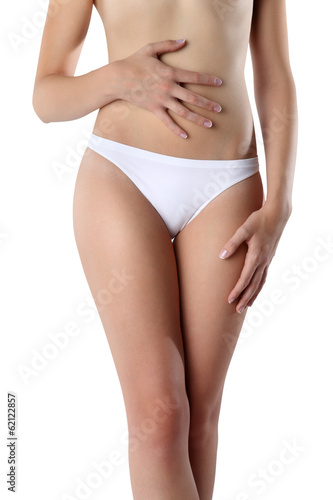 Photo: Woman's hands on stomach on white background wellness concept Woman's hands on stomach on white background wellness concept