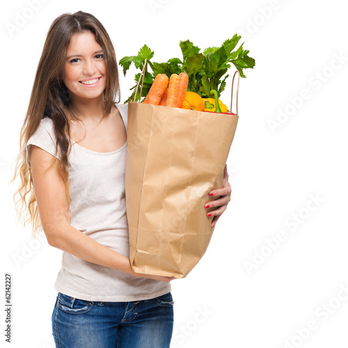 Photo: Smiling woman holding a bag full of vegetables Smiling woman holding a bag full of vegetables